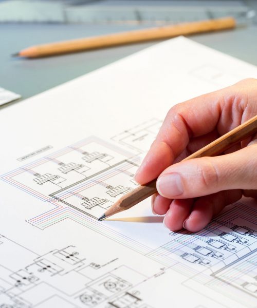 37426909 - macro close up of quantity surveyors hand reviewing technical drawing.